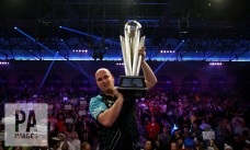Rob Cross celebrates with the trophy after winning the final during day fifteen of the William Hill World Darts Championship at Alexandra Palace, London. PRESS ASSOCIATION Photo. Picture date: Monday January 1, 2018. See PA story DARTS World. Photo credit should read: Steven Paston/PA Wire. RESTRICTIONS: Use subject to restrictions. Editorial use only. No commercial use.