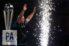 Rob Cross celebrates with the trophy after winning the final during day fifteen of the William Hill World Darts Championship at Alexandra Palace, London. PRESS ASSOCIATION Photo. Picture date: Monday January 1, 2018. See PA story DARTS World. Photo credit should read: Steven Paston/PA Wire. RESTRICTIONS: Use subject to restrictions. Editorial use only. No commercial use.