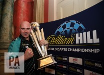 Rob Cross poses with the trophy during day fifteen of the William Hill World Darts Championship at Alexandra Palace, London. PRESS ASSOCIATION Photo. Picture date: Monday January 1, 2018. See PA story DARTS World. Photo credit should read: Steven Paston/PA Wire. RESTRICTIONS: Use subject to restrictions. Editorial use only. No commercial use.